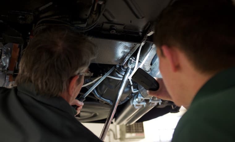 Under an Aston Martin being serviced